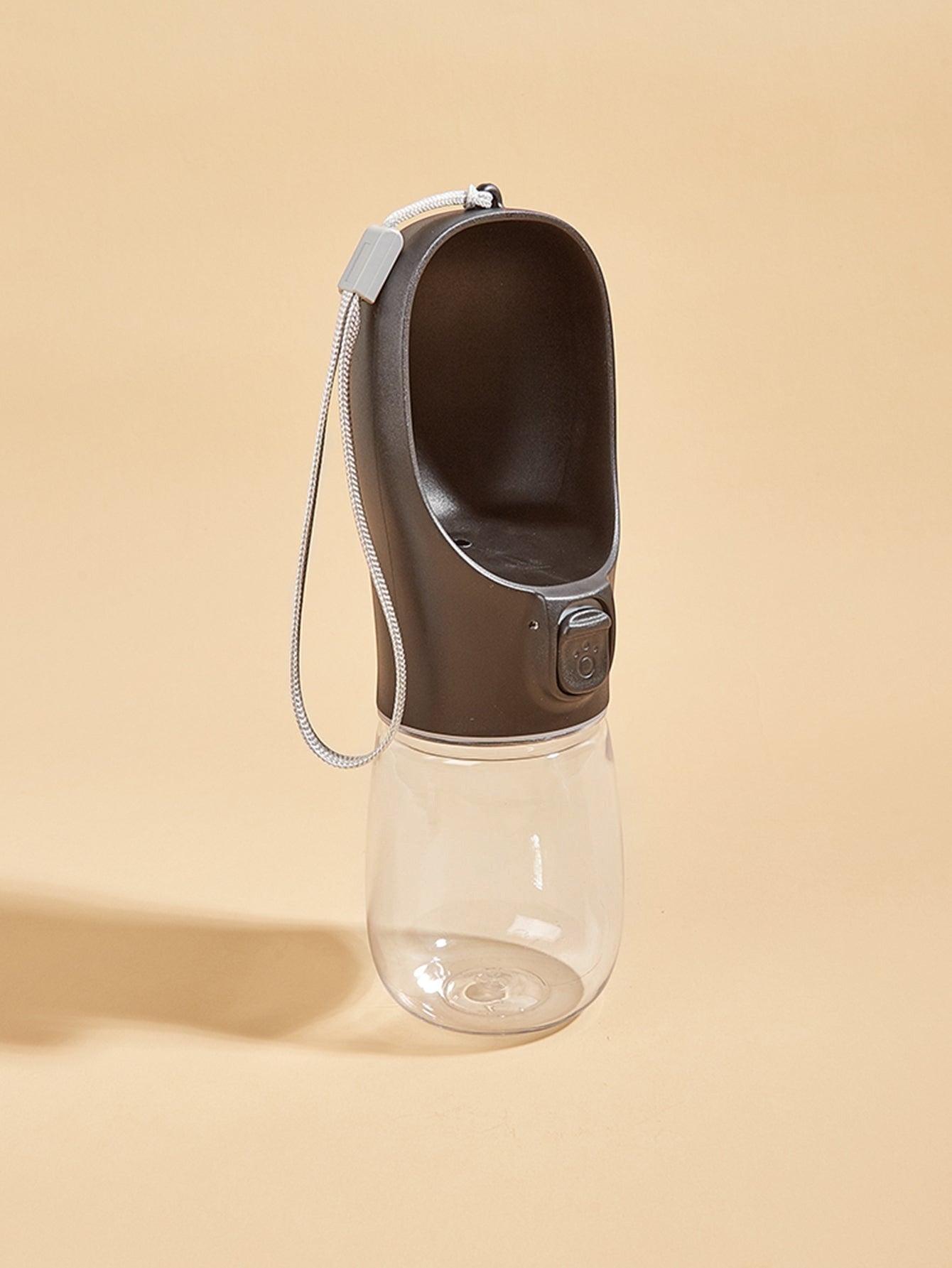 FurMidables black portable pet water bottle with a clear reservoir and integrated drinking trough for travel.