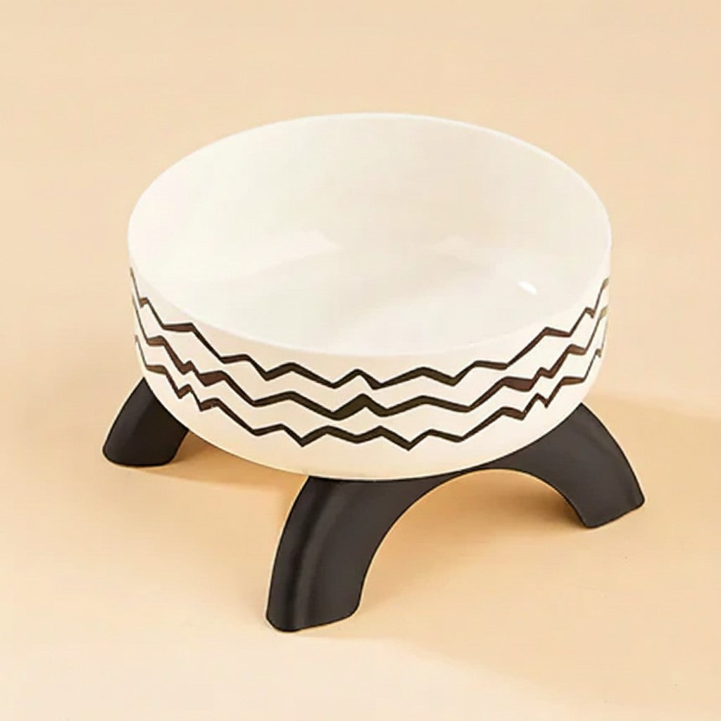 FurMidables elevated pet bowl with a white stainless steel insert, black zigzag pattern, and sturdy black legs.