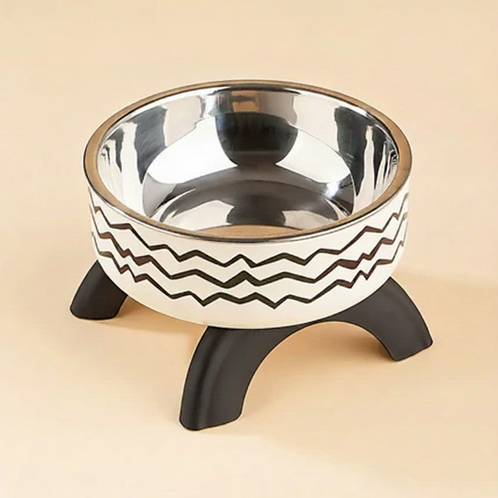 FurMidables elevated pet bowl with a stainless steel insert and a white base featuring a black zigzag pattern on legs.